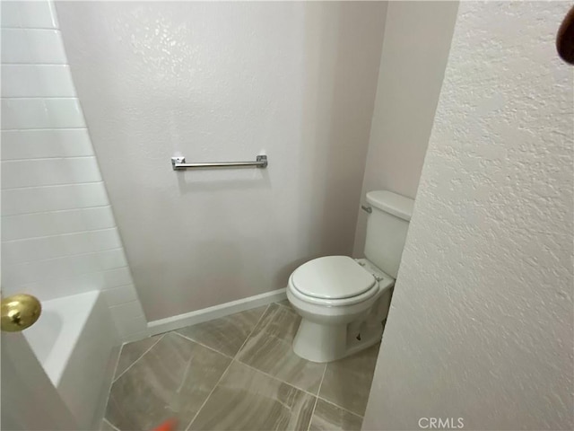 bathroom with tile patterned floors and toilet