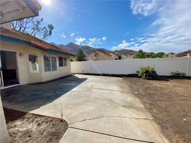 view of yard with a mountain view and a patio