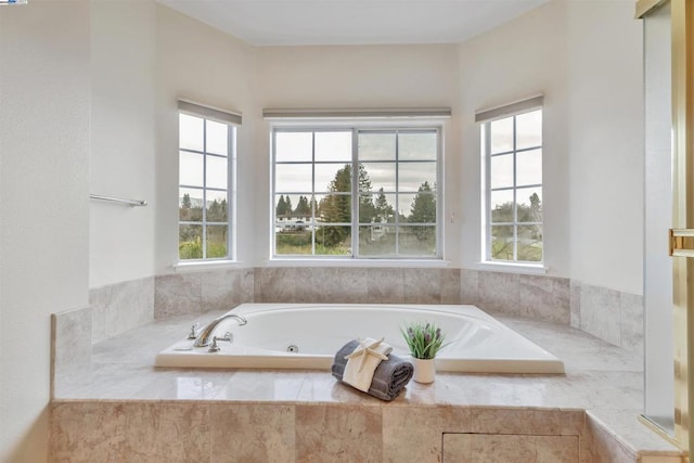 bathroom with a relaxing tiled tub