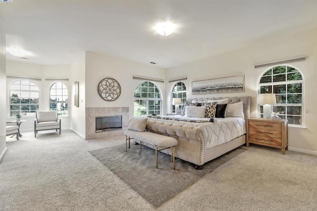 bedroom with carpet floors and a fireplace