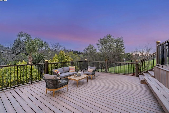 deck at dusk with an outdoor living space