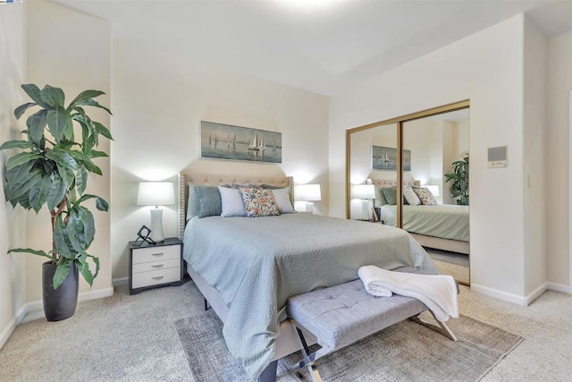 bedroom with light carpet and a closet