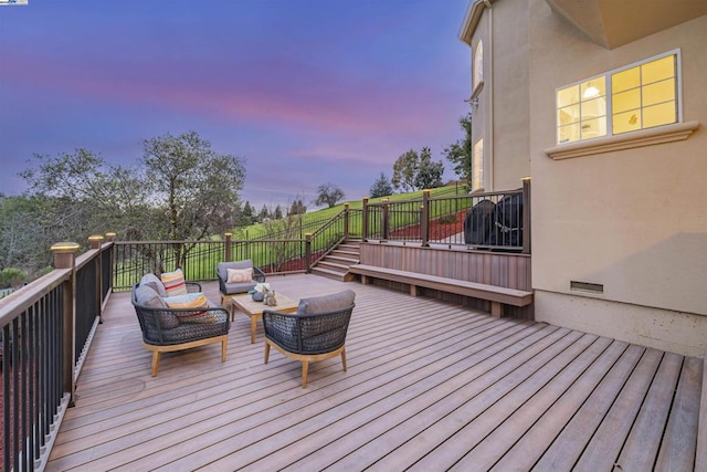 deck at dusk featuring outdoor lounge area