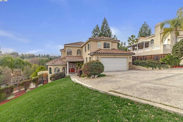 mediterranean / spanish-style house with a garage and a front lawn