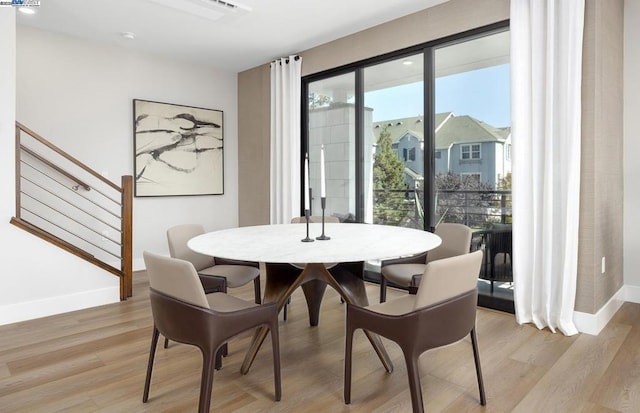 dining space with light wood-type flooring