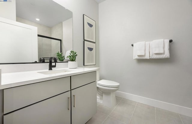 bathroom featuring toilet, vanity, tile patterned floors, and a shower with door