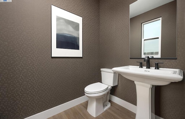 bathroom featuring toilet and hardwood / wood-style floors