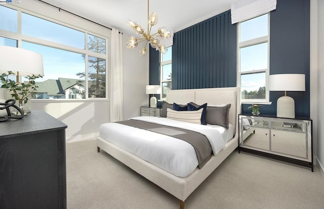 carpeted bedroom with multiple windows and an inviting chandelier