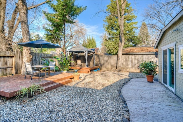 view of yard featuring a wooden deck and a gazebo