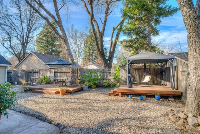 view of yard with a gazebo and a wooden deck