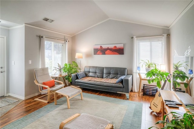 living room featuring ornamental molding, lofted ceiling, and wood-type flooring