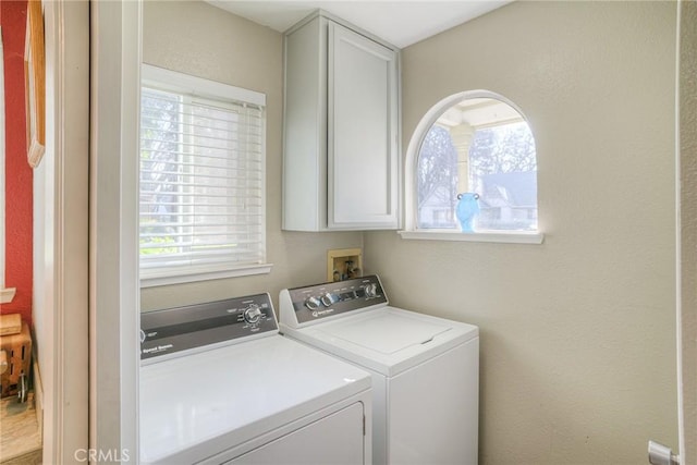 laundry room featuring cabinets and separate washer and dryer