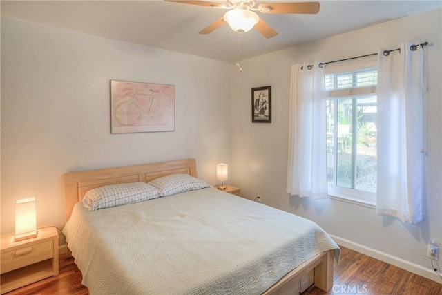 bedroom with ceiling fan and hardwood / wood-style floors