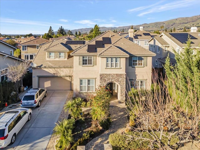 view of front property featuring a garage and a mountain view