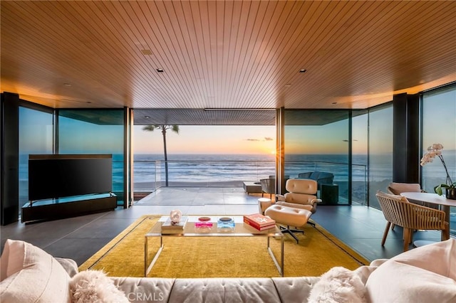 living room featuring a water view, wood ceiling, and floor to ceiling windows