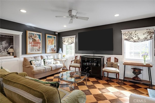 living room with ceiling fan and a healthy amount of sunlight