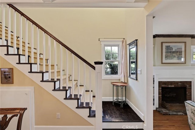 staircase with hardwood / wood-style flooring