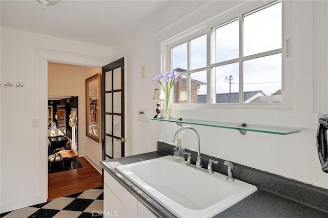 kitchen featuring white cabinetry and sink