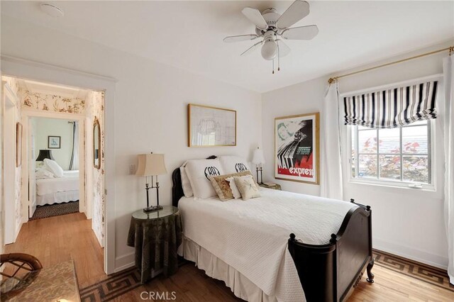 bedroom with ceiling fan and wood-type flooring