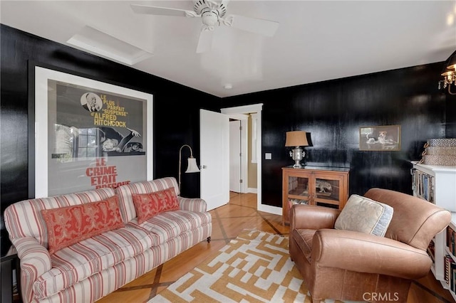 living room with light wood-type flooring and ceiling fan