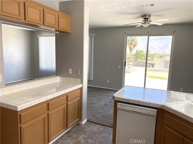 kitchen featuring ceiling fan, tile countertops, dishwasher, and kitchen peninsula