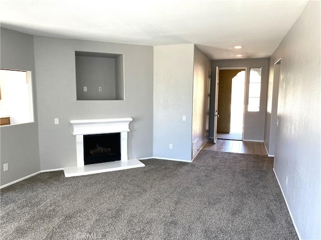 unfurnished living room featuring carpet