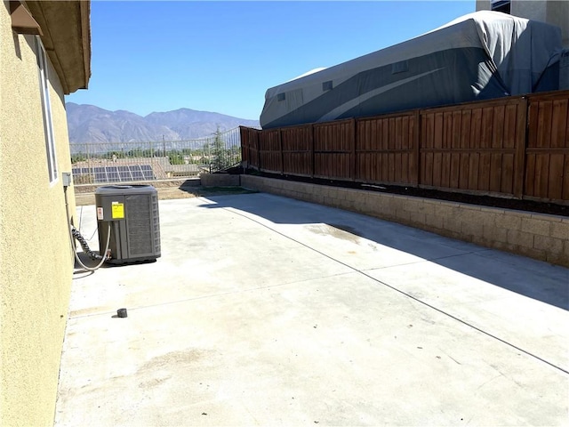 view of patio / terrace with a mountain view and central AC