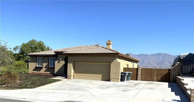 view of front facade featuring a garage and a mountain view