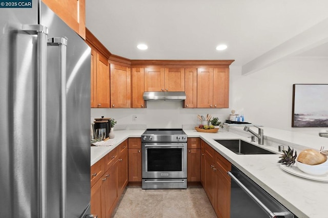 kitchen with light stone countertops, stainless steel appliances, and sink