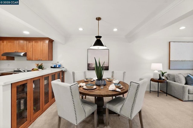 dining area with light carpet and ornamental molding