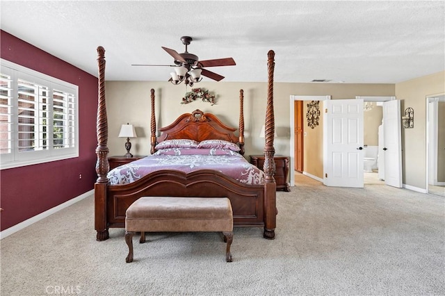 carpeted bedroom featuring ceiling fan, connected bathroom, and a textured ceiling