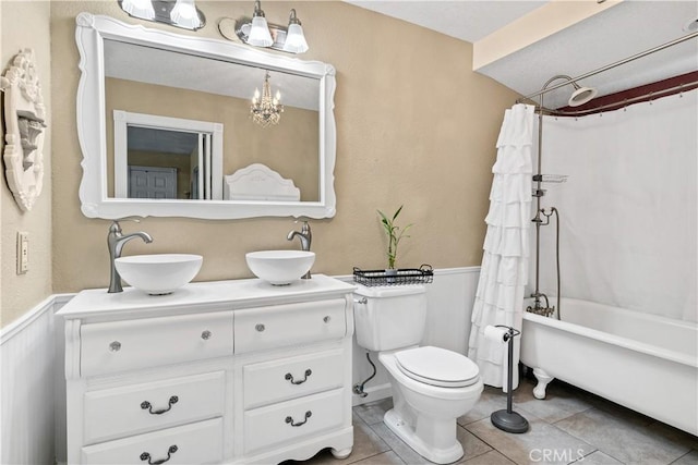 full bathroom with toilet, tile patterned floors, vanity, and shower / bath combo with shower curtain