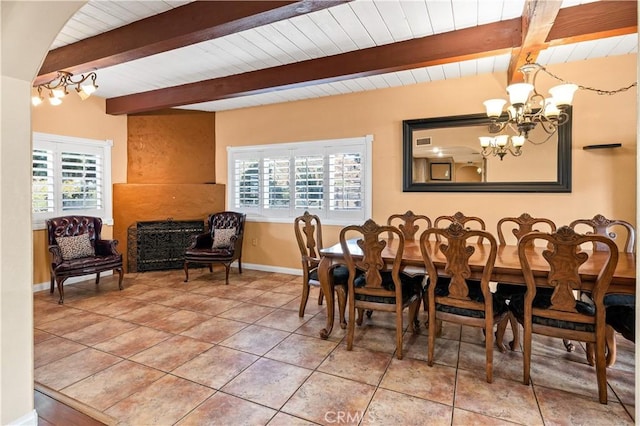 tiled dining room with an inviting chandelier, wood ceiling, plenty of natural light, and lofted ceiling with beams