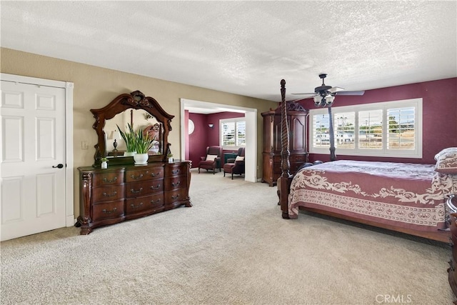 carpeted bedroom with a textured ceiling and ceiling fan