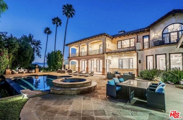 back of house with a patio area, an outdoor hangout area, and a balcony