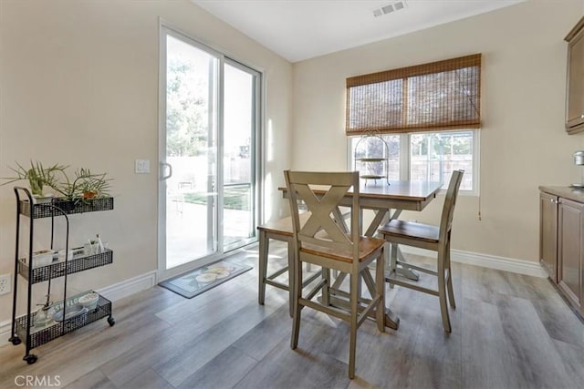 dining space with light hardwood / wood-style flooring