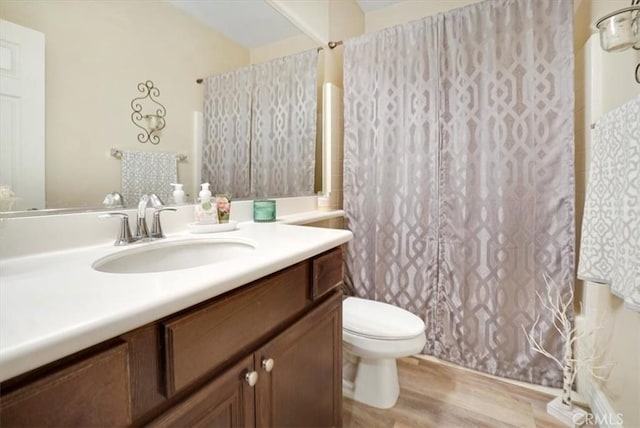 full bathroom with toilet, shower / bath combo, hardwood / wood-style floors, and vanity