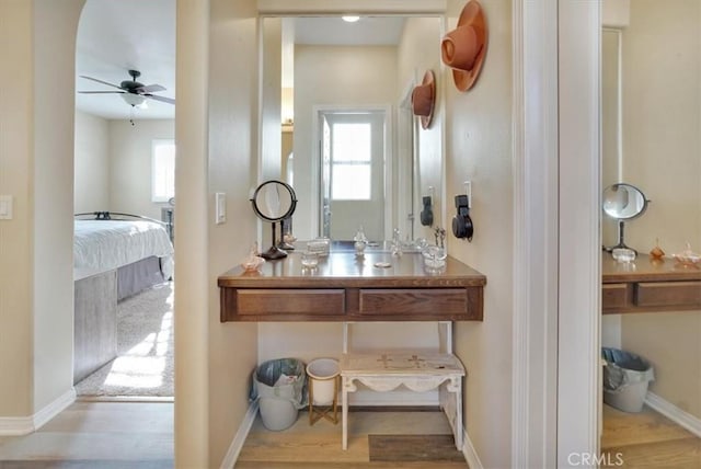 bathroom with ceiling fan and hardwood / wood-style floors