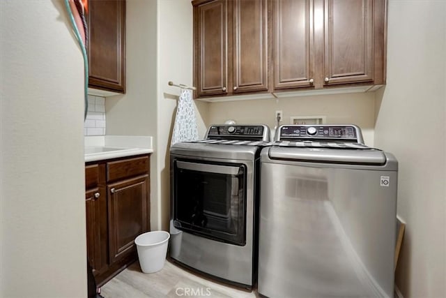 laundry area featuring cabinets and independent washer and dryer