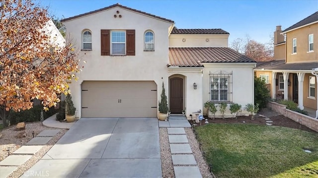 mediterranean / spanish home featuring a front lawn and a garage