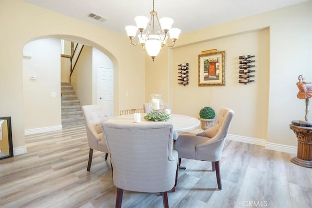 dining area featuring a chandelier and light hardwood / wood-style flooring