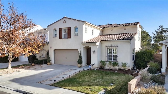 mediterranean / spanish-style house with a front yard and a garage