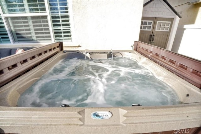 exterior details featuring a jacuzzi