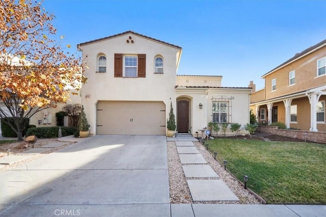 mediterranean / spanish home featuring a front lawn and a garage