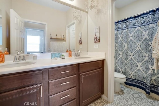 bathroom with toilet, a shower with curtain, tile patterned floors, and vanity