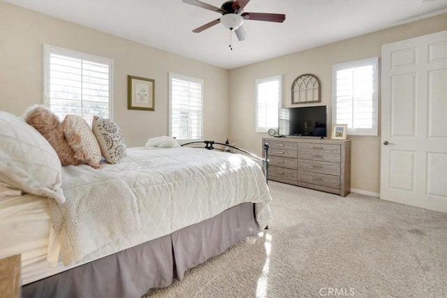 bedroom featuring ceiling fan and light carpet