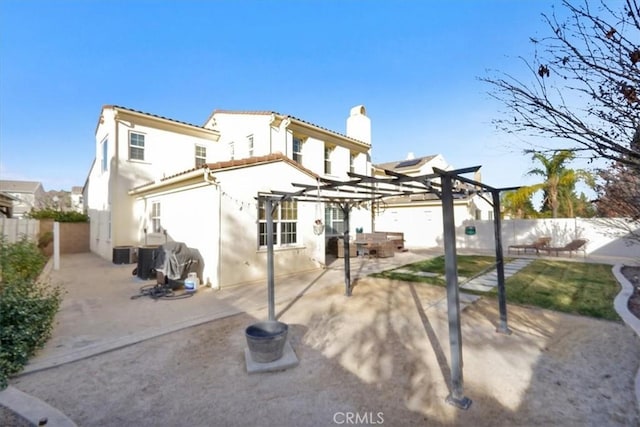 rear view of house featuring a pergola, central air condition unit, and a patio