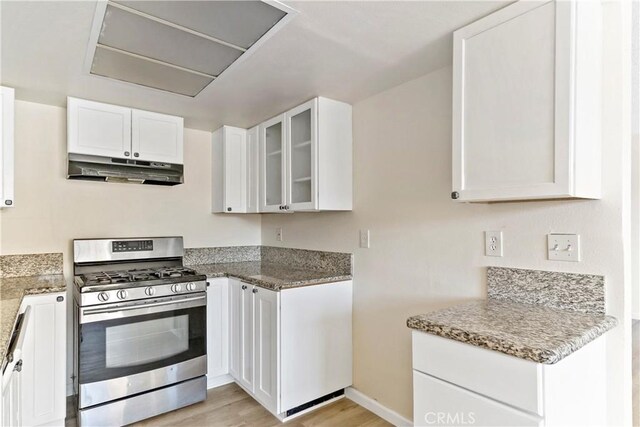 kitchen featuring gas range, white cabinets, and light wood-type flooring