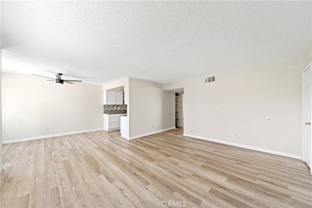 unfurnished living room with light wood-type flooring, ceiling fan, and a textured ceiling