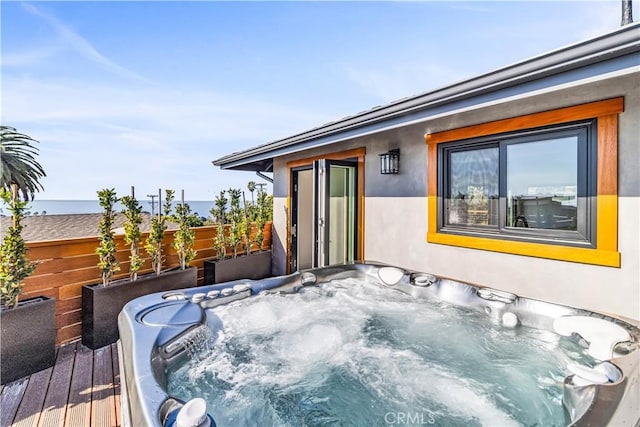 wooden terrace with a hot tub